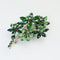 1950s vintage green rhinestones flower brooch on white background