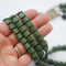 close up of Triple row 1960s vintage beaded necklace in matt forest green