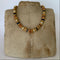 Necklace with multicolored beads on a textured surface