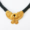 plaited black beads and matt gold plated front vintage necklace on white background