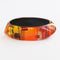 red, orange and yellow vintage bangle in an abstract pattern by Gail Klevan