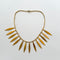 Gold plated aztec style leaf necklace on a white