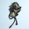 Sumptuous multi media large brooch by Greek designer Nikolas Frangos in a dark bronze plated featuring large opaque grey and mushroom coloured cabochons with mink rhinestones and a double drop. Very unusual!