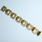 Gold bracelet with geometric links on a white background