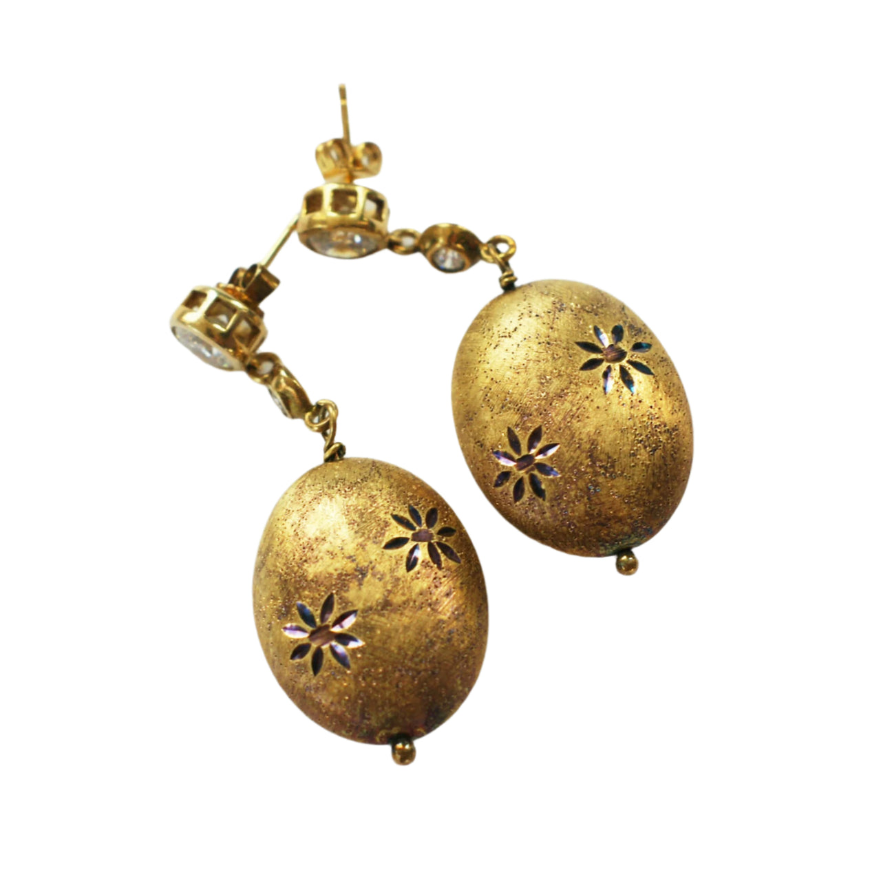 A pair of vintage silver gilt earrings with a starburst pattern engraved on the bottom, for pierced ears.