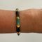 Bangle in black and blue being worn