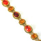 autumnal vintage bracelet by Joan Rivers that dates back to the 1990s. It has orange, brown and topaz glass stones that are set on gold plated metal 