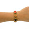 autumnal vintage bracelet by Joan Rivers that dates back to the 1990s. It has orange, brown and topaz glass stones that are set on gold plated metal