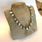 Necklace with stone-like beads on a mannequin bust