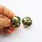 vintage Orena gold plate and green clip-on earrings held in hand