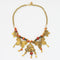 1980s vintage necklace with gold plated metal chain, orange and brown beads and gold plated butterflies with beads hanging down on a white background