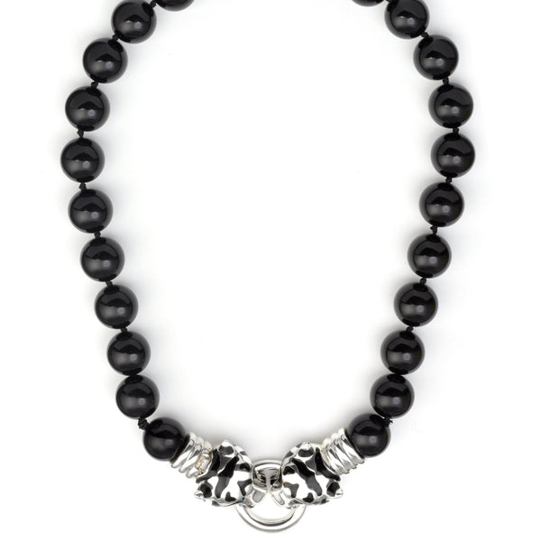 Black beaded necklace with silver clasp on a white background