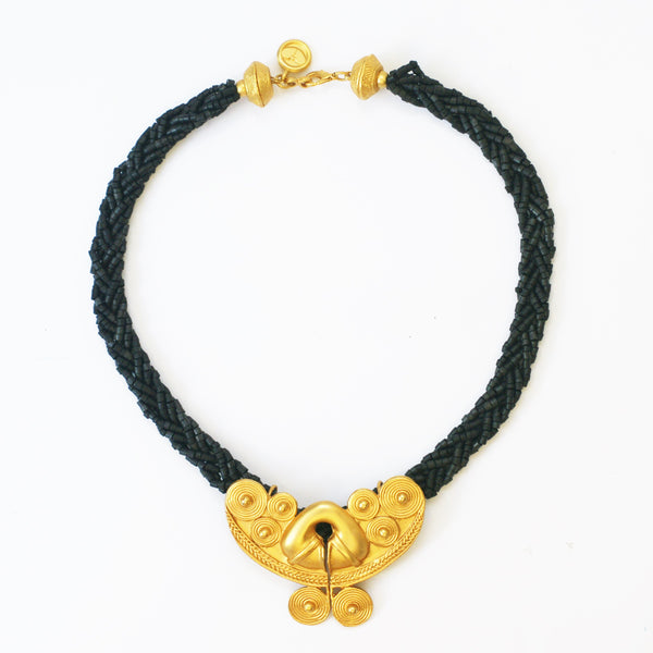 plaited black beads and matt gold plated front vintage necklace on white background