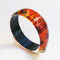 red, orange and yellow vintage bangle in an abstract pattern by Gail Klevan