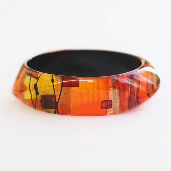 red, orange and yellow vintage bangle in an abstract pattern by Gail Klevan