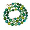 Green beaded necklace on a white background