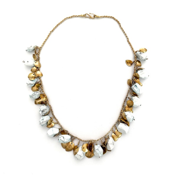 Necklace with gold and white beads on a white background