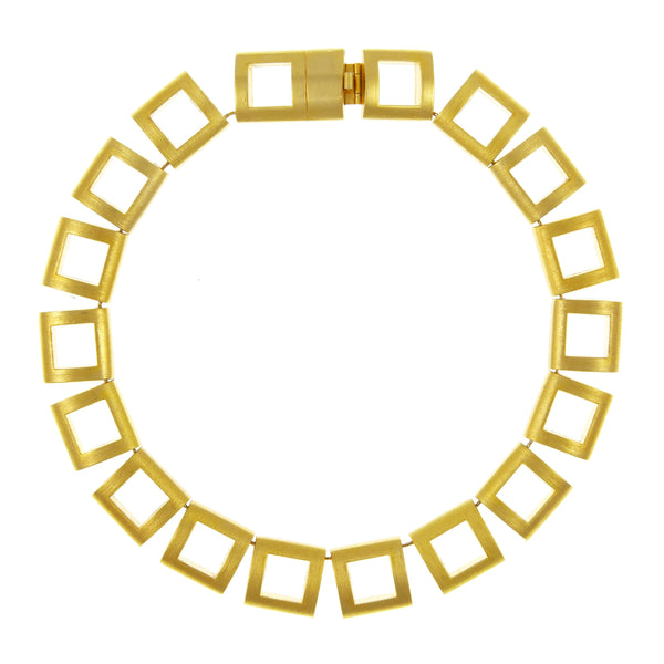 A gold-plated Helena Rubenstein necklace with square links and a metallic clasp.
