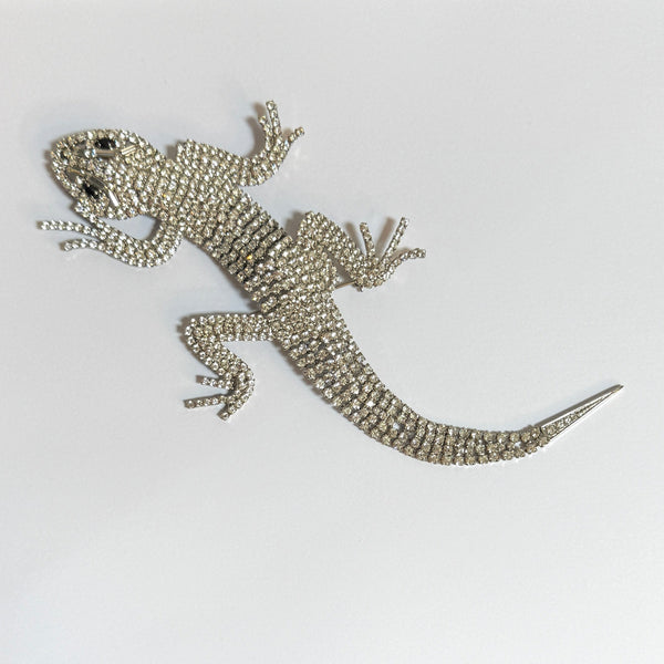 Decorative lizard brooch large made of crystals on a white background