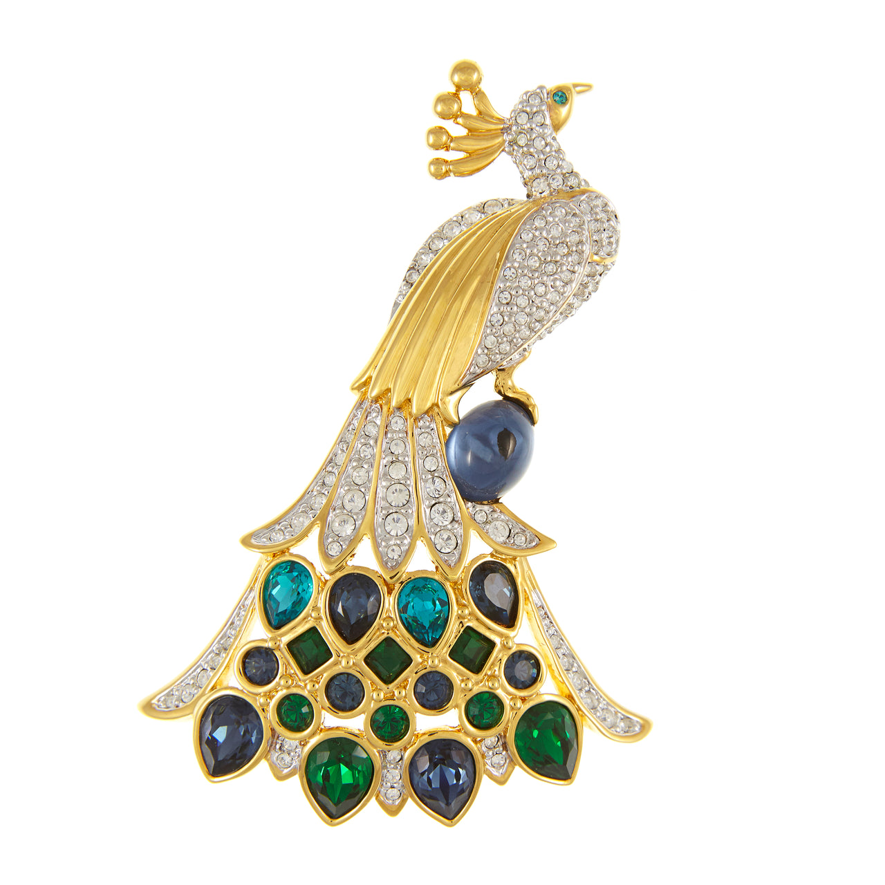 A gold-toned peacock brooch decorated with pavé-set clear crystals, green and blue teardrop and oval gemstones, and a dark blue pearl, shown on a plain white background.