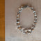 rock crystal beaded necklace on beige background