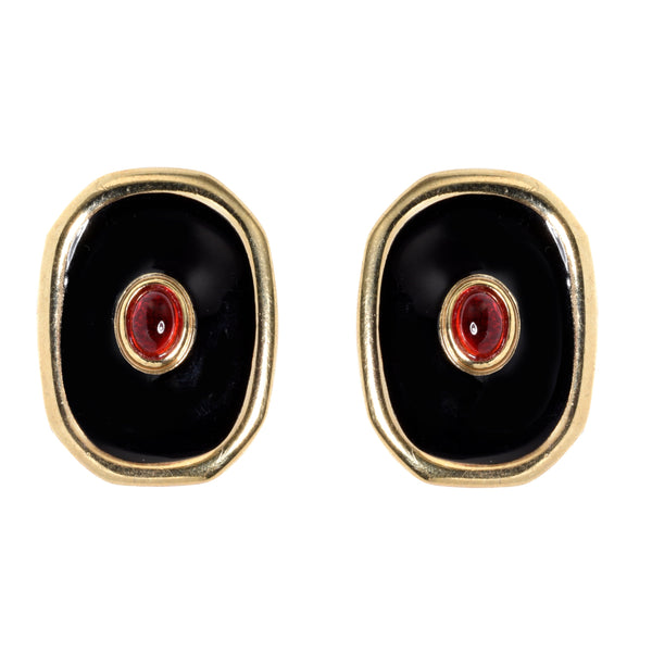 Pair of earrings with black stones and red centers on a white background