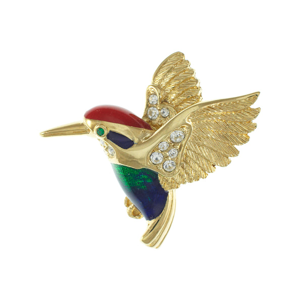 A gold bird brooch shaped like a hummingbird, featuring a red crown, dark blue and green body, small green eye, and clear rhinestone accents on the wings and body, shown on a plain white background.