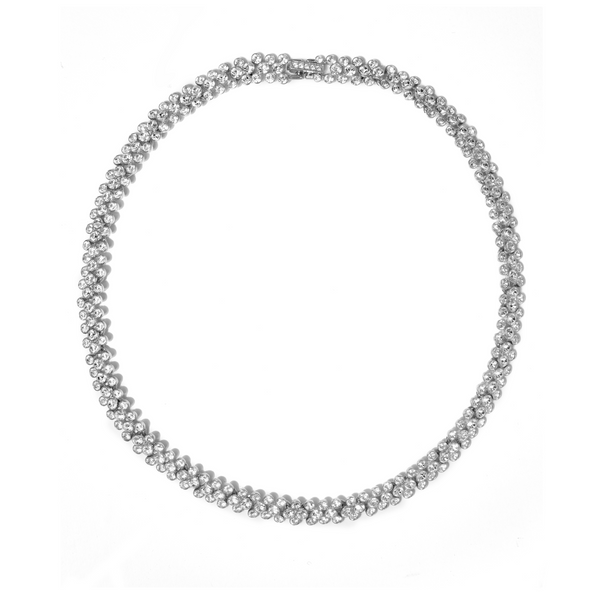 Silver coloured necklace on a white background with clear crystals
