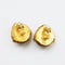reverse of 1980s vintage clip-on earrings in amber yellow and matt gold-plate on a white background