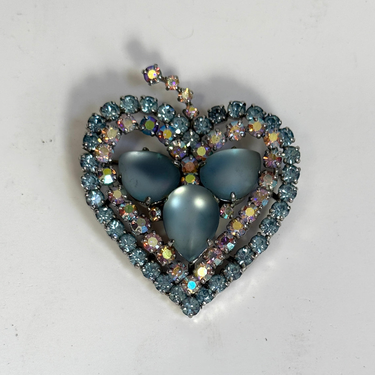 blue sparkly brooch from the 1950s on a white background