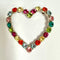 brightly coloured heart shaped brooch on  a white background vintage large statement