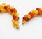 close up of the clasp of 1980s vintage resin necklace in fiery red and amber beads