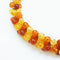 close up of 1980s vintage resin necklace in fiery red and amber beads