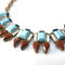 J crew vintage necklace with turquoise rectangular stones and pearshape deep red stones with a matte gold-plated chain