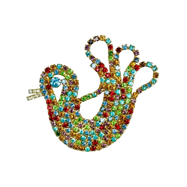A colourful chicken shaped brooch or pin featuring a mix of red, green, blue, yellow, and orange rhinestones, photographed on a plain white background.
