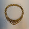 Gold chain necklaceon a light gray background