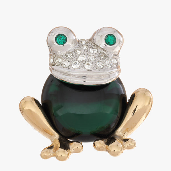 A frog-shaped brooch featuring a dark green enamel body, gold-tone legs and feet, a silver-tone head paved with clear rhinestones, and green gemstone eyes, shown on a plain light gray background.