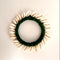 green wool and white cowrie shell bangle on a white background