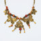 1980s vintage necklace with gold plated metal chain, orange and brown beads and gold plated butterflies with beads hanging down on a white background