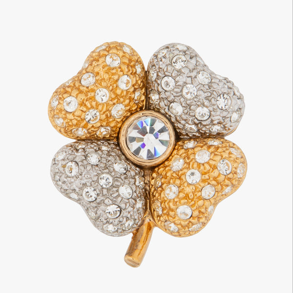 A gold and silver-tone four-petal flower brooch embellished with clear rhinestones, featuring a central round iridescent crystal on a clear gray background.