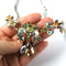 close up of vintage swarovski crystal necklace being held in a hand
